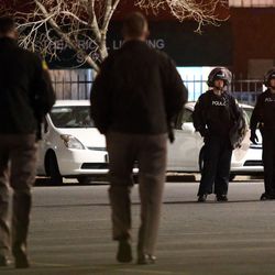 Police work to secure an area near The Road Home after an officer-involved shooting took place in Salt Lake City on Saturday, Feb. 27, 2016. 
