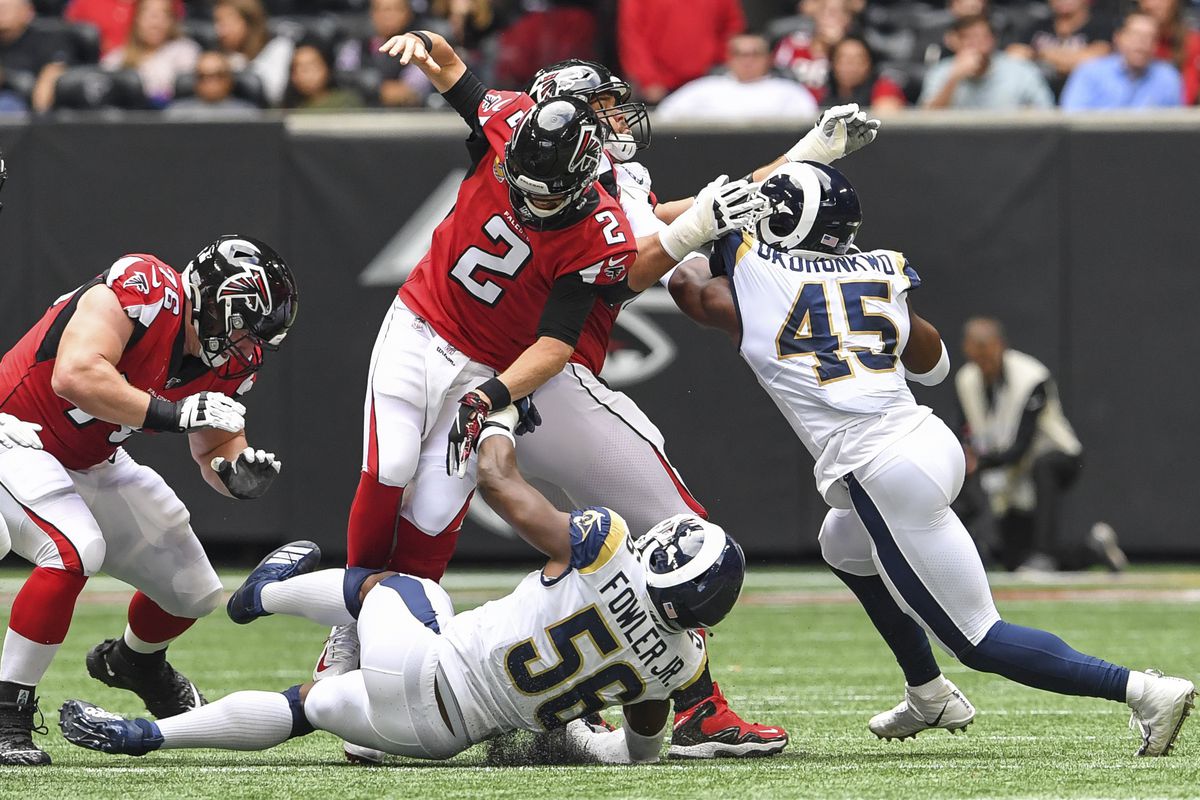 Los Angeles Rams defensive end Dante Fowler hits Atlanta Falcons quarterback Matt Ryan knocking the ball loose during the first half at Mercedes-Benz Stadium.