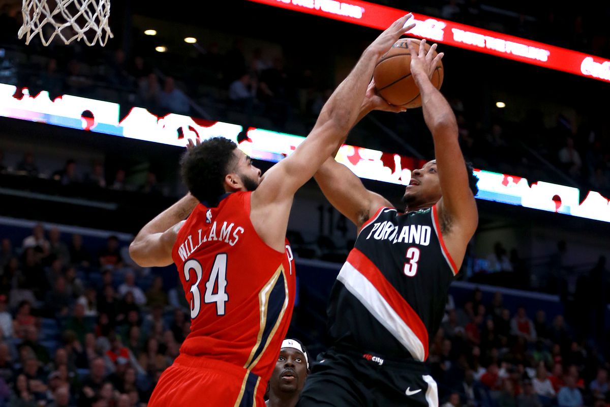 CJ McCollum of the Portland Trail Blazers shoots against Kenrich Williams of the New Orleans Pelicans during a NBA game at the Smoothie King Center on November 19, 2019 in New Orleans, Louisiana.