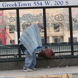 FILE - A homeless man tries to keep warm at a TRAX station in downtown Salt Lake City on Thursday, Dec. 8, 2016.