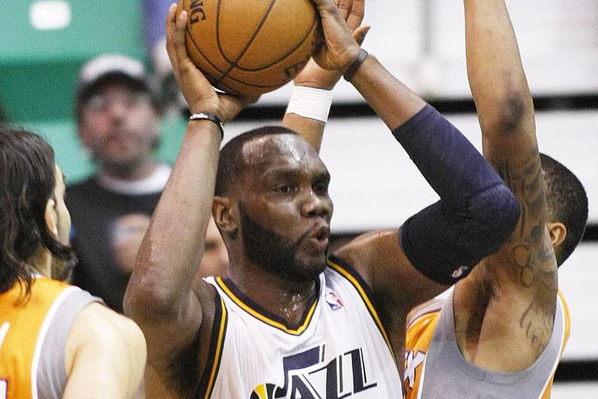Utah's Al Jefferson works to get a shot off as the Utah Jazz and the Phoenix Suns play Wednesday, March 27, 2013 in Energy Solutions arena. Utah wins 103-88.