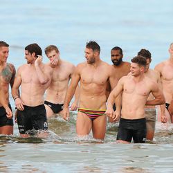 Players walk in from the water during a Collingwood Magpies AFL recovery session at St Kilda Sea Baths in Melbourne, Australia. 