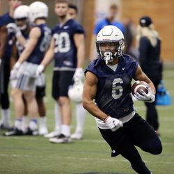 Trey Dye runs the ball during Brigham Young University football practice in Provo on Monday, Feb. 27, 2017.