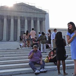 People line up in front of the Supreme Court in Washington, Monday, June 24, 2013, before it opened for its last scheduled session. The Supreme Court has 11 cases, including the term's highest profile matters, to resolve before the justices take off for summer vacations, teaching assignments and international travel. The court is meeting Monday for its last scheduled session, but will add days until all the cases are disposed of. 