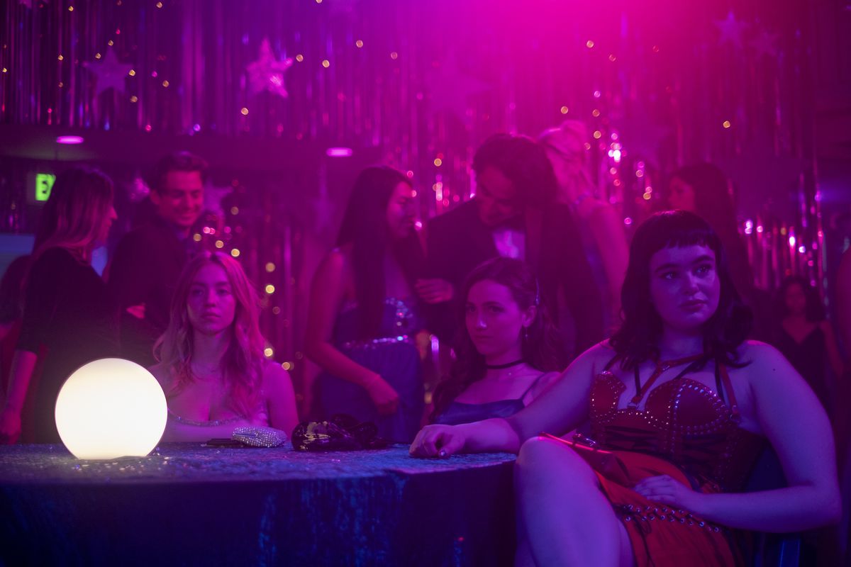 From left, Sydney Sweeney, Maude Apatow, Barbie Ferreira on Euphoria, sitting at a table in formal wear.