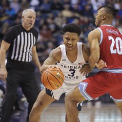 Loyola Marymount Lions guard Cam Shelton (20) defends Brigham Young Cougars guard Te’Jon Lucas (3) during an NCAA basketball game at Marriott Center in Provo on Thursday, Feb. 24, 2022.