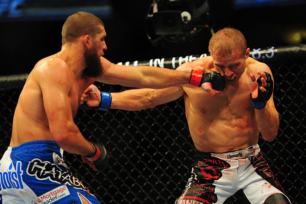 Jul 21, 2012; Calgary, AB, CANADA; Court McGee (blue shorts) and Nick Ring (not pictured) during the middleweight bout of UFC 149  at the Scotiabank Saddledome. Mandatory Credit: Anne-Marie Sorvin-US PRESSWIRE