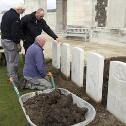 A group of workers for the Commonwealth War Graves Commission discuss the removal of a row of damaged WWI headstones at Tyne Cot cemetery in Zonnebeke, Belgium on Monday, April 15, 2013. With nearly 12,000 graves the cemetery is the largest Commonwealth war cemetery in the world in terms of burials. The damaged headstones will be removed and replaced with newly engraved stones in preparation for the upcoming centenary which begins in 2014. 