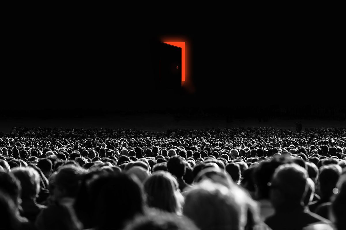 Large crowd of people look into darkness in front of them. A mysterious door is cracked open, revealing glowing red light.