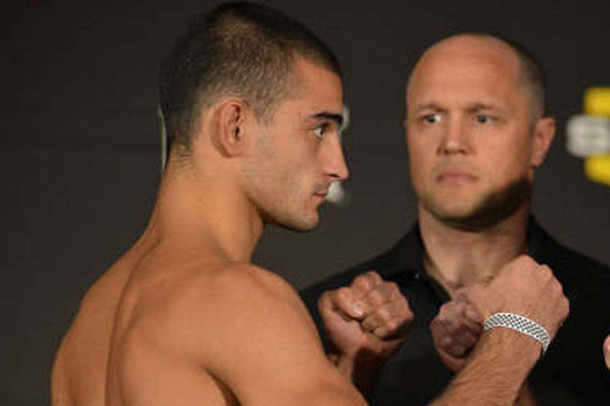 Andrey Koreshkov (left) stares down his opponent at the Bellator 74 weigh-ins as Bellator promoter Bjorn Rebney (right) looks on.