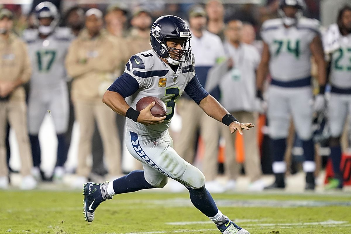 Quarterback Russell Wilson of the Seattle Seahawks carries the ball against the defense of the San Francisco 49ers in the game at Levi’s Stadium on November 11, 2019 in Santa Clara, California.