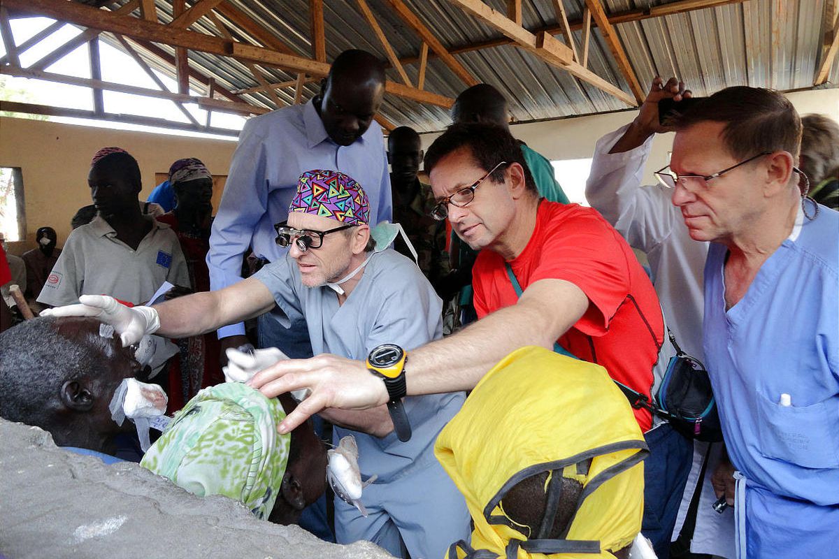 John Dau, left, Dr. Roger Furlong, Dr. Geoffrey Tabin, co-director of international ophthalmology at Moran Eye Center and Dr. Alan Crandall, co-director of international ophthalmology at Moran Eye Center help patients in South Sudan.