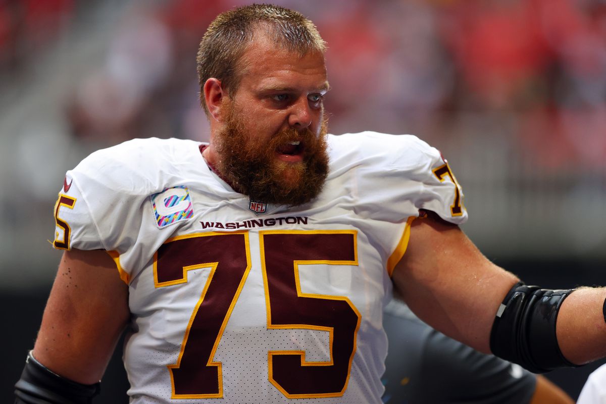 Brandon Scherff #75 of the Washington Football Team leaves the field after an injury in the third quarter against the Atlanta Falcons at Mercedes-Benz Stadium on October 03, 2021 in Atlanta, Georgia.