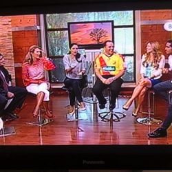 David Patey on the set of a local daytime television program wearing the jersey of his club, Club Sport Herediano.