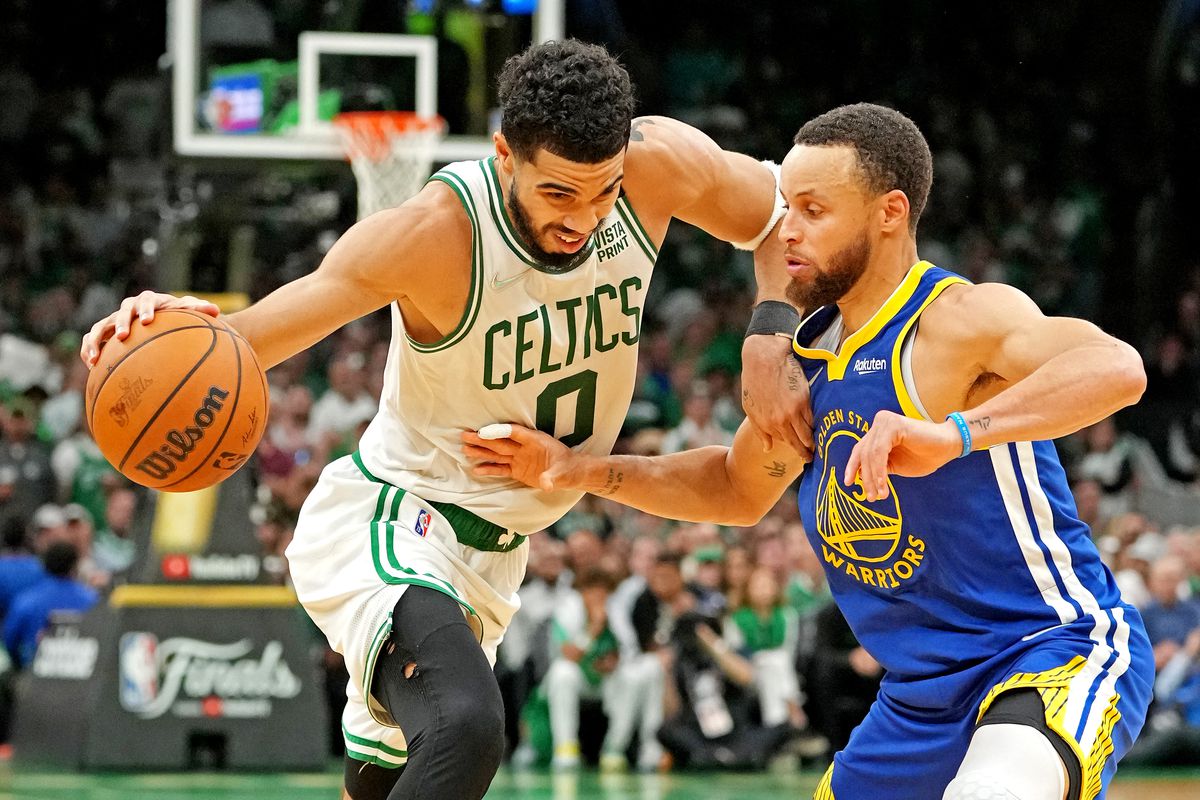 Stephen Curry of the Golden State Warriors defends Boston Celtics star Jayson Tatum.