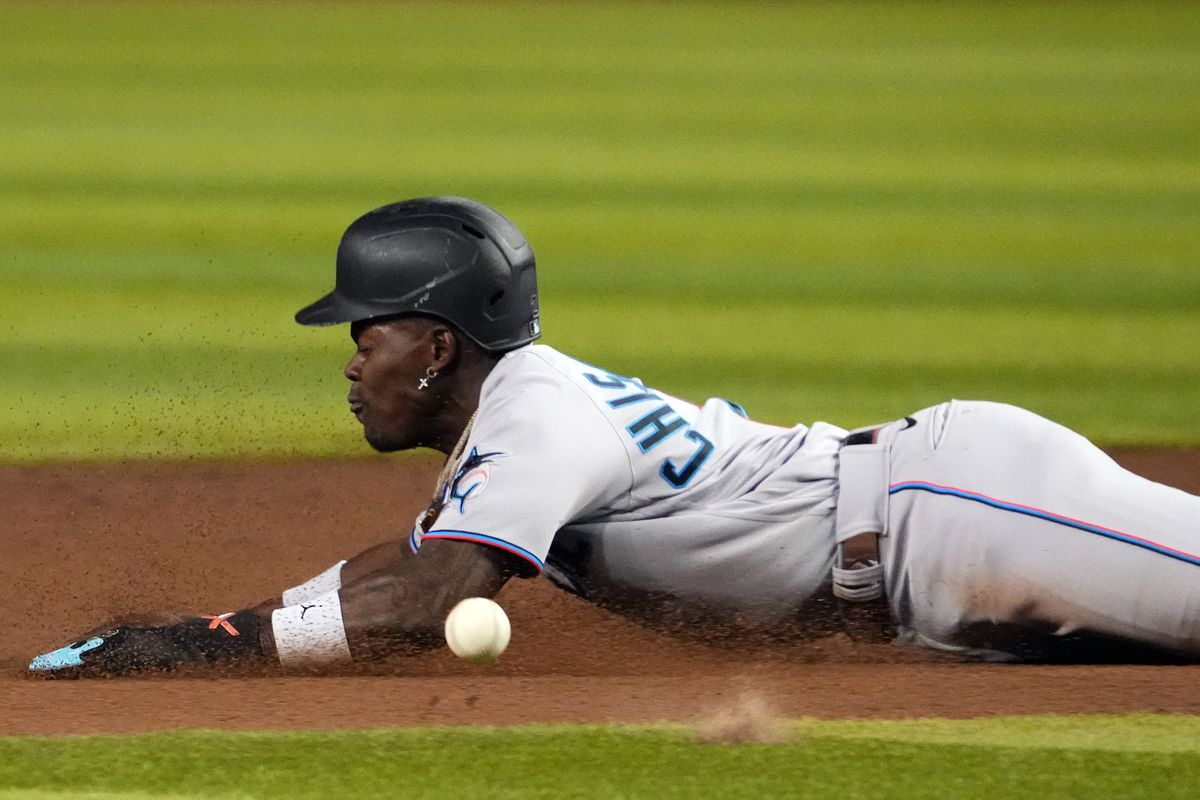 Miami Marlins center fielder Jazz Chisholm Jr. (2) slides into second base for a steal against the Arizona Diamondbacks during the fifth inning at Chase Field.