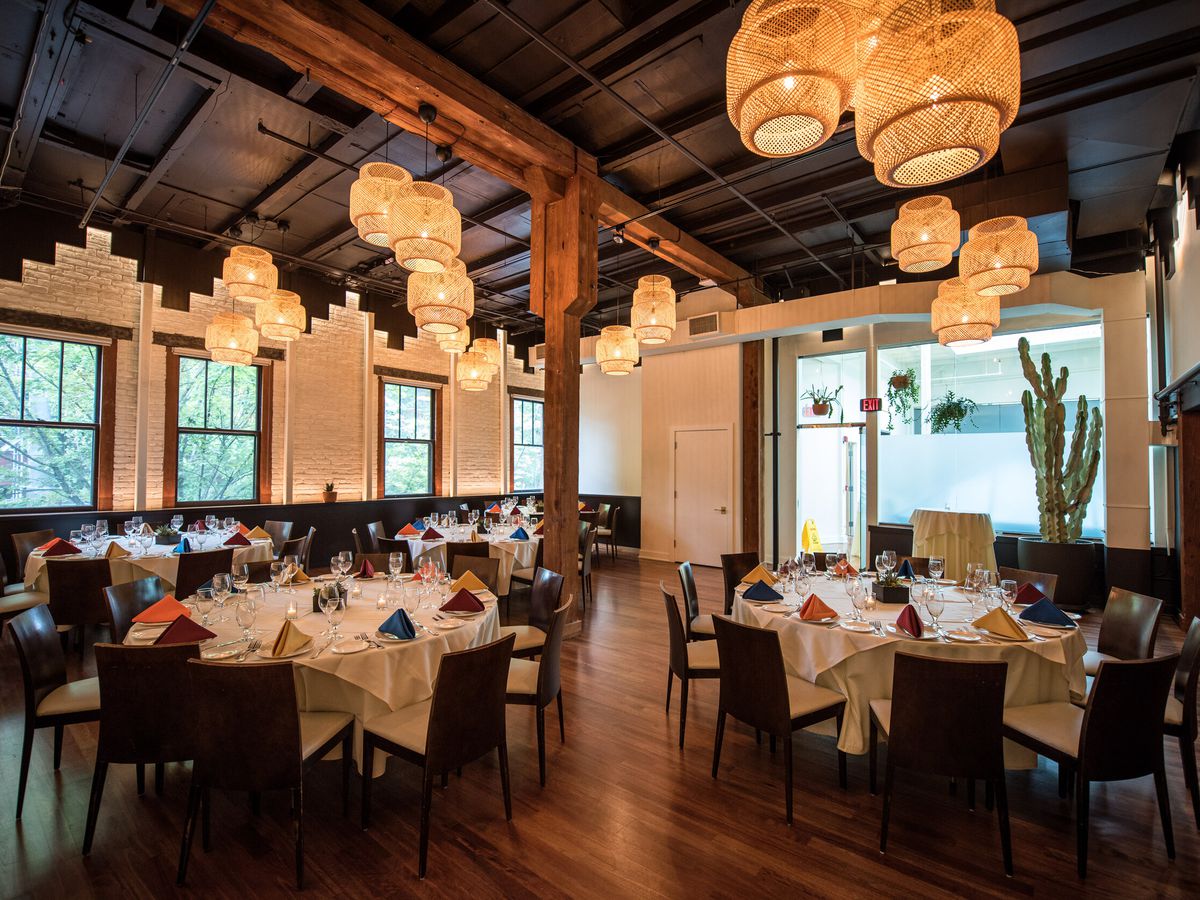 Round tables are lit by globe light fixtures within Andina’s private dining room.