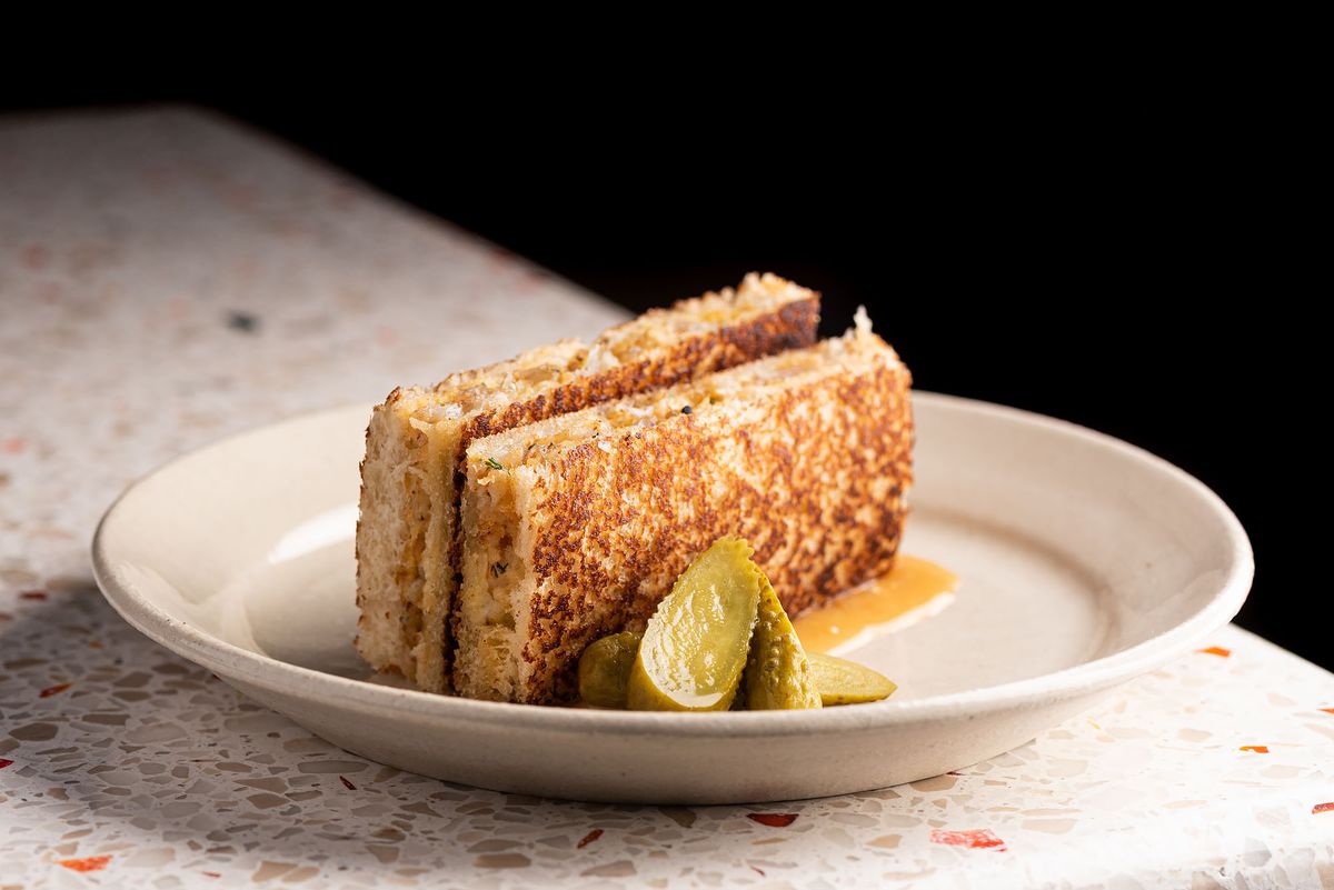 A crispy small tuna melt sandwich, presented on its side.