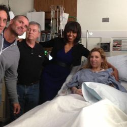 This April 18, 2013 photo provided by Alfred Colonese shows from left Alfred Colonese, Mick Henn, Dale Abbott, first lady Michelle Obama, Heather Abbott, Jason Geremia, and Michelle Dalrymple at Brigham and Women's Hospital in Boston. Heather Abbott was scrambling to get off the sidewalk when the force of the second blast blew her through the restaurant doorway. 