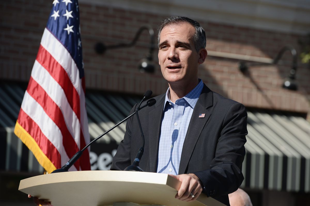 Los Angeles Mayor Eric Garcetti standing at a podium
