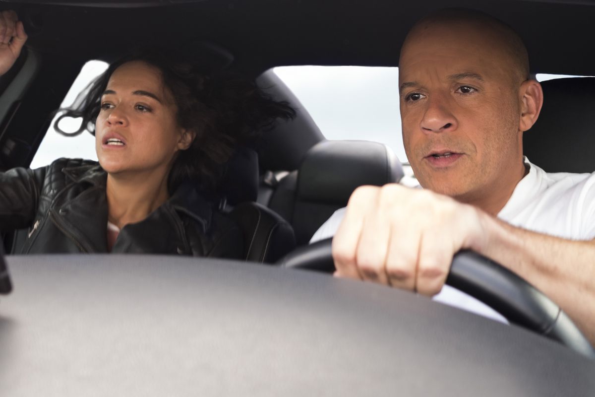 Dom drives while Letty hangs on for dear life.