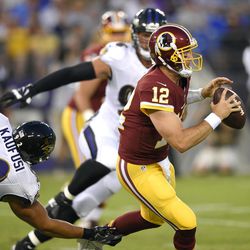 Washington Redskins quarterback Colt McCoy (12) tries to outrun Baltimore Ravens defensive end Bronson Kaufusi in the first half of a preseason NFL football game, Thursday, Aug. 10, 2017, in Baltimore. Kaufusi is a former BYU lineman and returned LDS missionary.