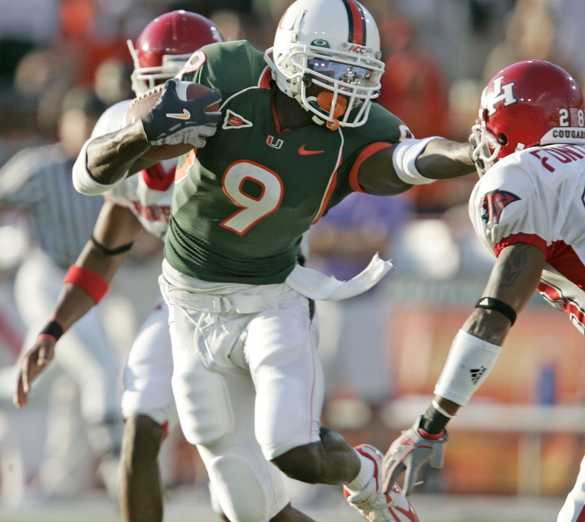 University of Miami’s Lance Leggett carries the ball on a lo