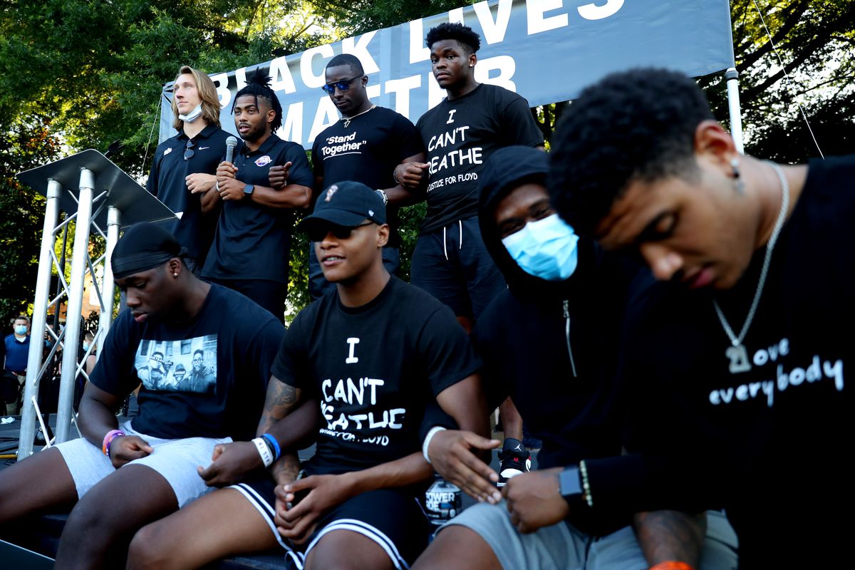 Clemson University football players Trevor Lawrence, Darien Rencher, Cornell Powell, and Mike Jones Jr., pray following the “March for Change” protest at Bowman Field on June 13, 2020 in Clemson, South Carolina.