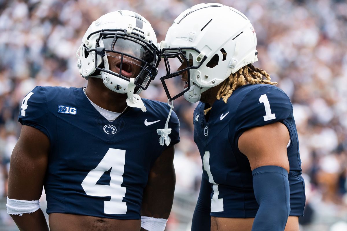 Penn State cornerback Kalen King (4) celebrates with safety Jaylen Reed (1) after Reed intercepted a pass in the first half of a NCAA football game against Indiana Saturday, Oct. 28, 2023, in State College, Pa.