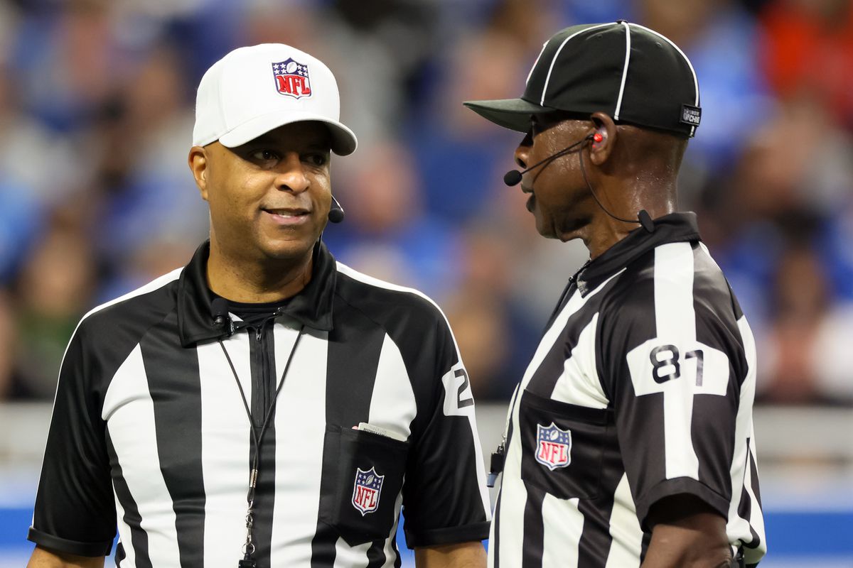 Referee Adrian Hill (29) and umpire Roy Ellison (81) talk with each other between plays during an NFL football game between the Detroit Lions and the Minnesota Vikings in Detroit, Michigan USA, on Sunday, January 1, 2023.