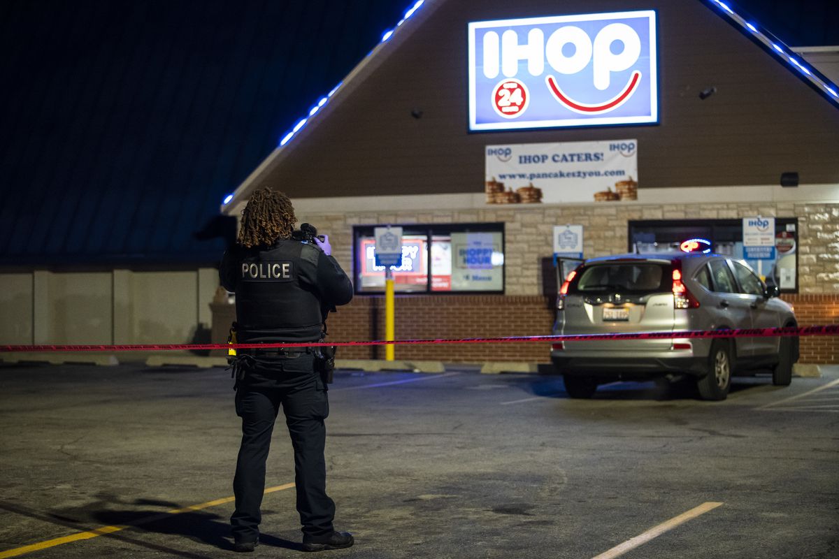 A man with a gun being pursued by police shot a woman inside an IHOP restaurant Saturday night in Evanston after taking her hostage, police said.