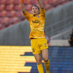 Seattle Reign FC goalkeeper Casey Murphy (26) jumps to block a shot on goal from the Utah Royals FC during their match at Rio Tinto Stadium in Sandy on Friday, June 28, 2019.