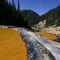 Water flows through a series of sediment retention on Aug. 14, 2015, The ponds were built to reduce heavy metal and chemical contaminants from the Gold King Mine wastewater accident, in the spillway about a quarter-mile downstream from the mine outside Silverton, Colo.