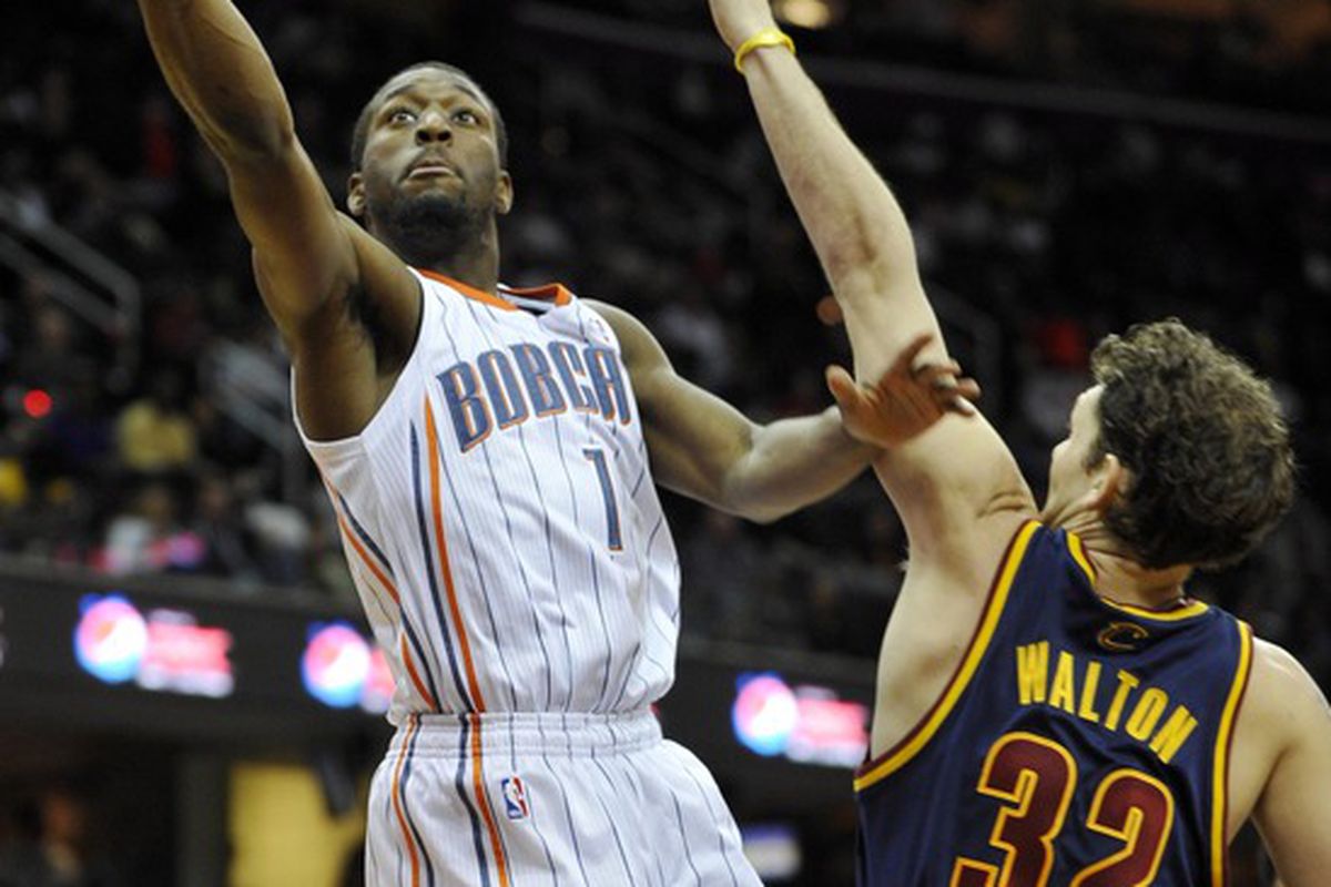 Apr 10, 2012; Cleveland, OH, USA; Charlotte Bobcats point guard Kemba Walker (1) shoots while defended by Cleveland Cavaliers small forward Luke Walton (32) in the second quarter at Quicken Loans Arena. Mandatory Credit: David Richard-US PRESSWIRE