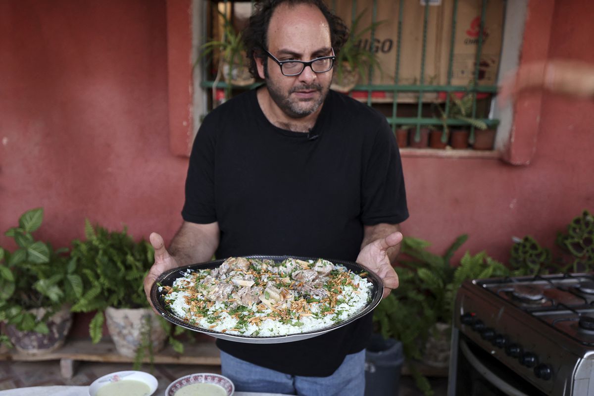 Fadi Kattan holds a platter of food