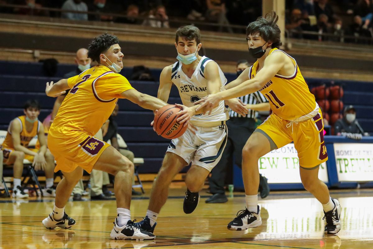 New Trier’s Peter Kanellos (3) and Loyola’s Max Garcia (2) and Miles Boland (11) battle for the ball. 
