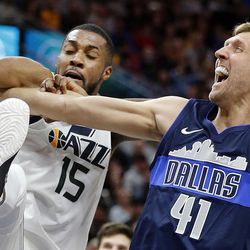 Utah Jazz forward Derrick Favors is called for a foul while rebounding against Dallas Mavericks forward Dirk Nowitzki during NBA basketball in Salt Lake City on Saturday, Feb. 24, 2018.