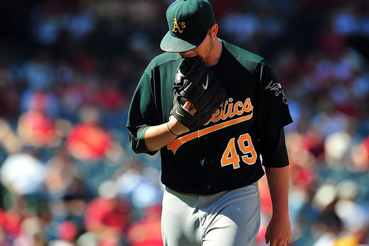 September 13, 2012; Anaheim, CA, USA; Oakland Athletics starting pitcher Brett Anderson (49) reacts after being relieved in the seventh inning against the Los Angeles Angels at Angel Stadium. Mandatory Credit: Gary A. Vasquez-US PRESSWIRE
