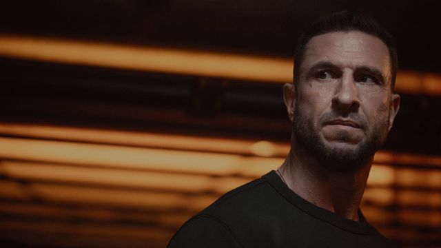 Pablo Schreiber as Master Chief in the Halo TV series without his armor on looking angry
