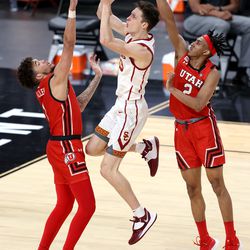 Utah Utes forward Timmy Allen (1) and Utah Utes guard Ian Martinez (2) defend USC Trojans guard Drew Peterson (13) as Utah and USC play in the Pac-12 Tournament at T-Mobile Arena in Las Vegas on Thursday, March 11, 2021. USC won 91-85 in double overtime.