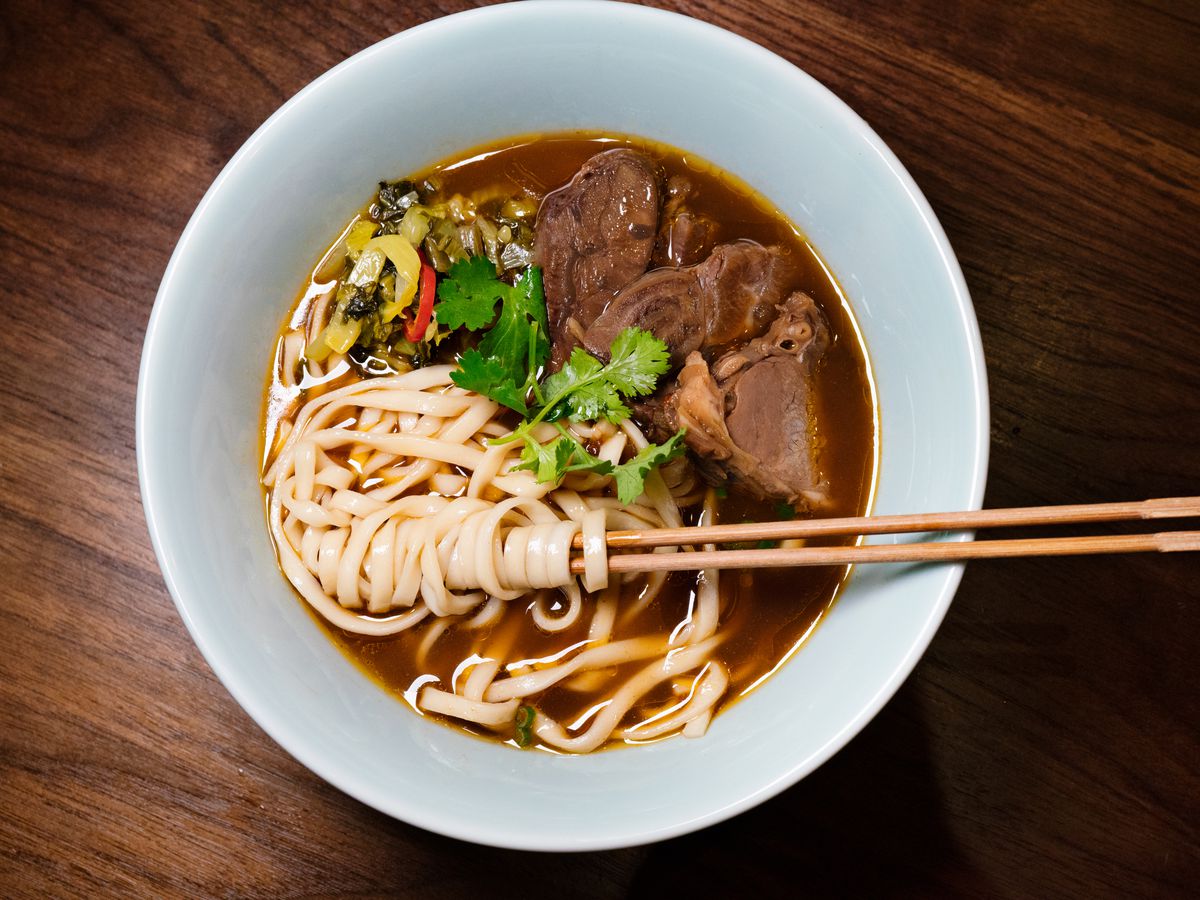 Beef noodles soup, with noodles artfully wrapped around chopsticks, from Ho Foods