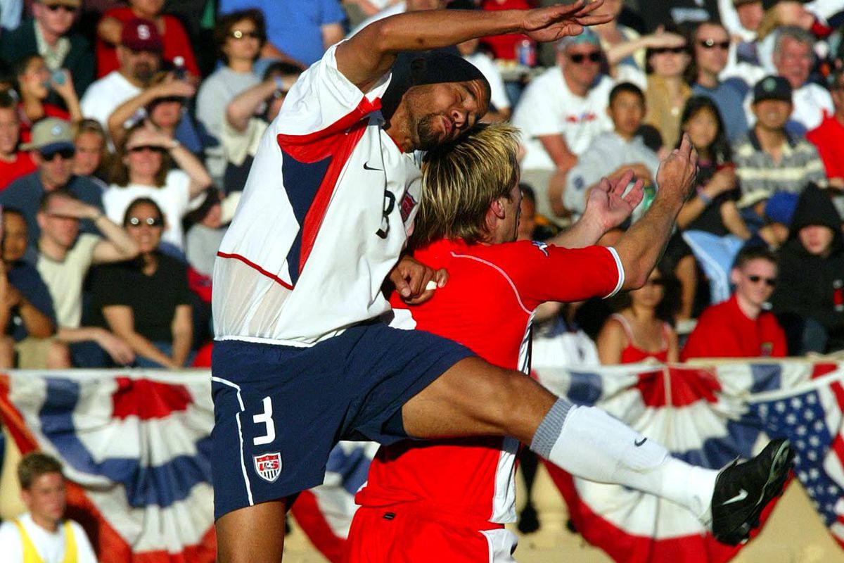 USA defensive player C.J Brown (L) heads the ball against Wales forward Gareth Taylor during first half action 26 May 2003 in San Jose California.