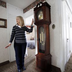 Deanna Golden stands in her parents' home Monday, Oct. 7, 2013, as she talks about her parents, Jerry and Edith Dunn, who were born the same year and died last week within hours of each other. This clock was stopped at midnight when her mother started having problems.