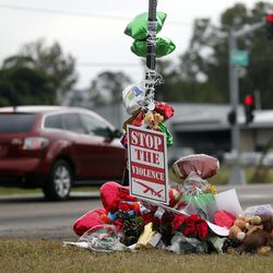 A memorial of flowers and balloons are placed at the scene , Tuesday, Dec. 6, 2016 where ex-NFL player Joe McKnight was killed in a road rage incident last week in Terrytown, La.. Ronald Gasser, the man who fatally shot McKnight in a New Orleans suburb during a road rage dispute, was arrested late Monday, Dec. 5, 2016, jailed on a charge of manslaughter. 
