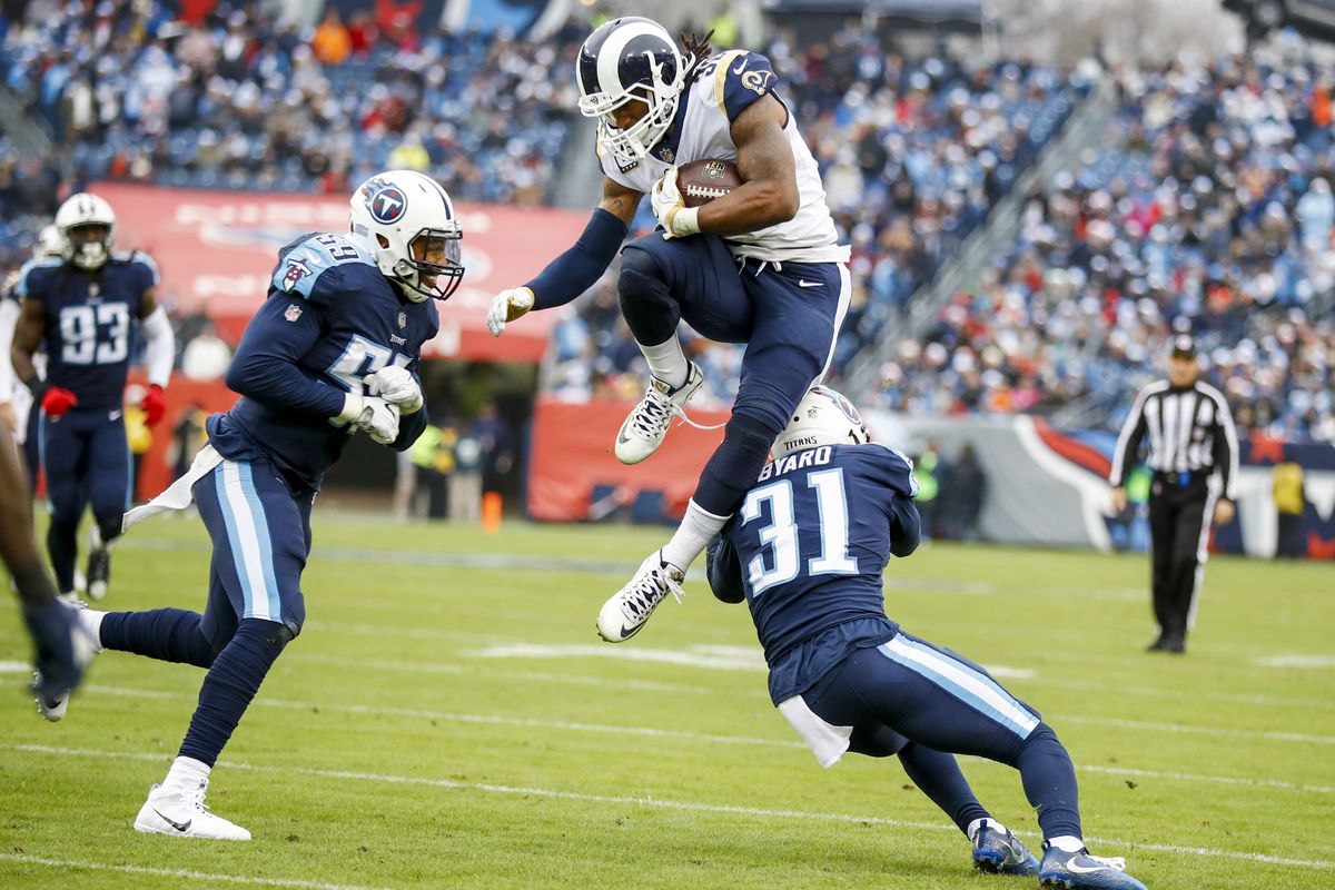 Los Angeles Rams RB Todd Gurley hurdles Tennessee Titans S Kevin Byard