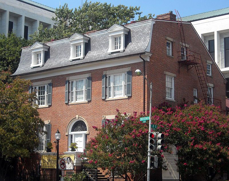 The exterior of the Belmont-Paul Women’s Equality National Monument. The facade is red brick with a grey roof and multiple windows.