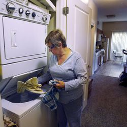 Billie Coleman does laundry in her apartment at Liberty CityWalk Apartments in Salt Lake City on Friday, Nov. 11, 2016, in preparation for a visit from her grandchildren.