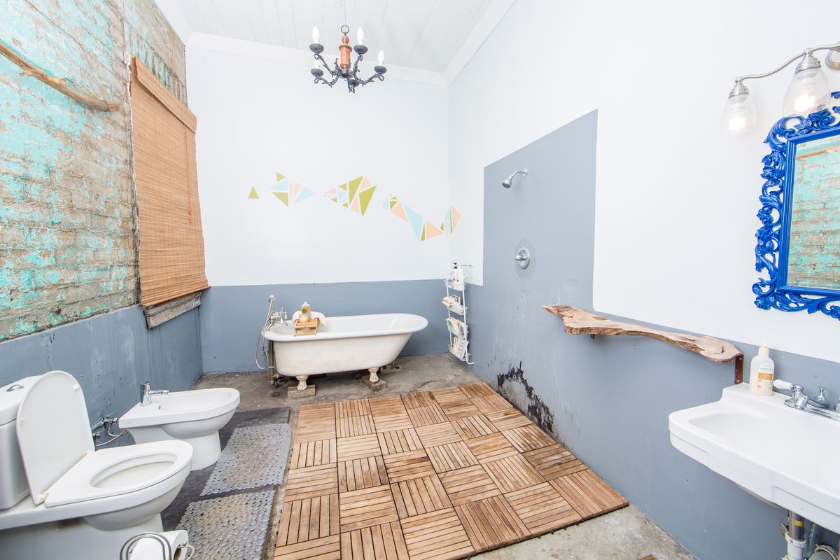 The bathroom of the house, which has standalone appliances and a bidet. 