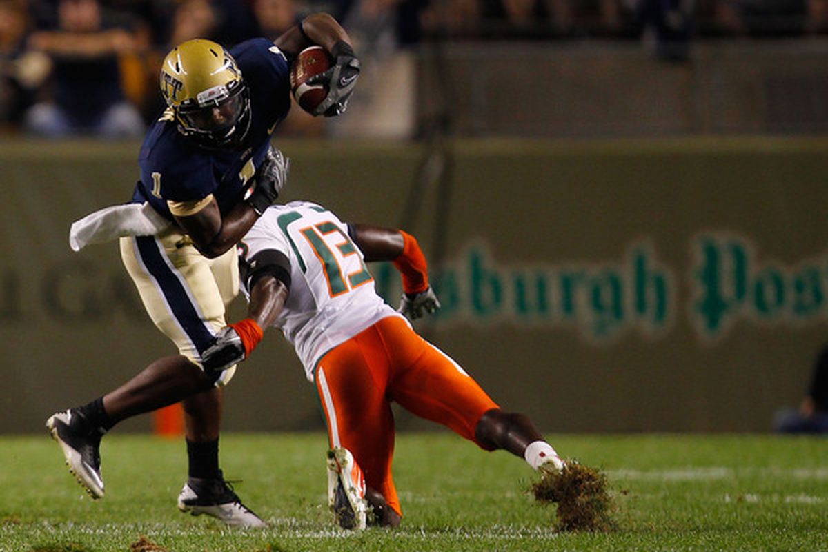PITTSBURGH - SEPTEMBER 23:  Ray Graham #1 of the Pittsburgh Panthers evades a tackle by Ryan Hill #13 of the Miami Hurricanes on September 23 2010 at Heinz Field in Pittsburgh Pennsylvania.  (Photo by Jared Wickerham/Getty Images)