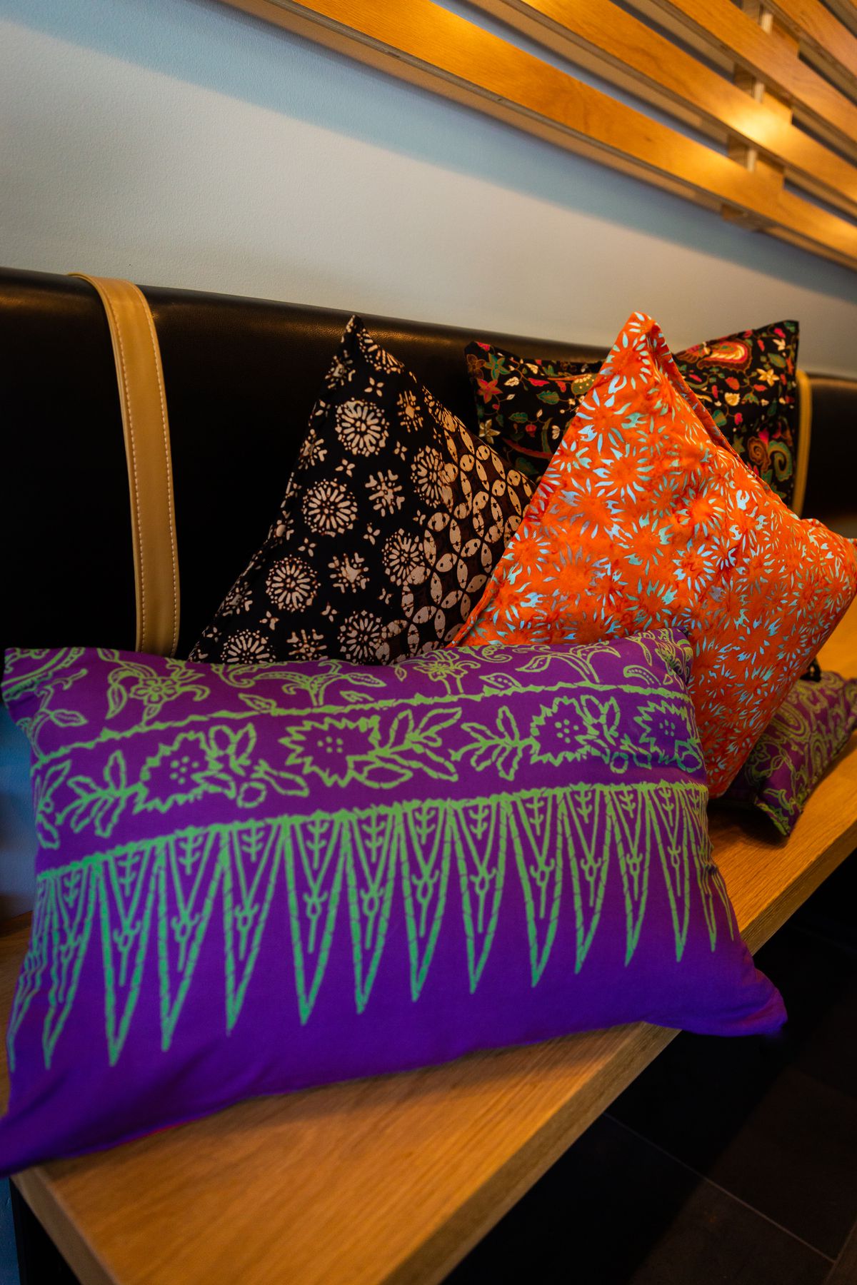 Decorative, brightly colored pillows inside Warung Siska